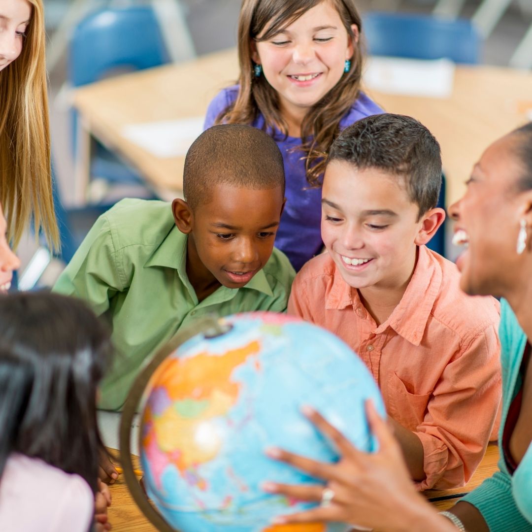 students looking at globe
