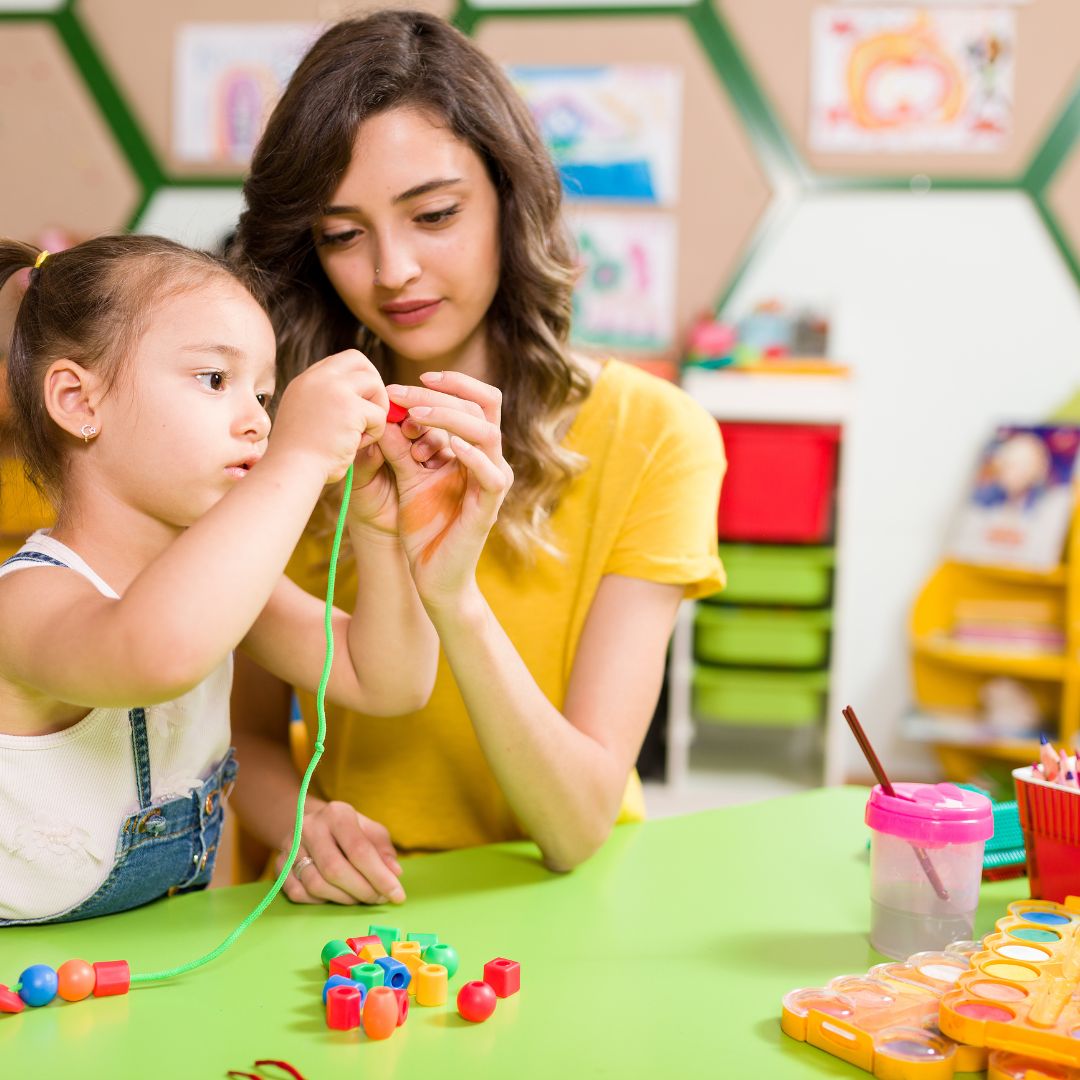 preschooler working with teacher on a project