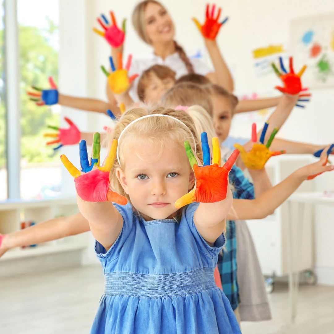 kids holding out their hands covered in pain