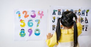 Preschool kid learning the alphabet and numbers.