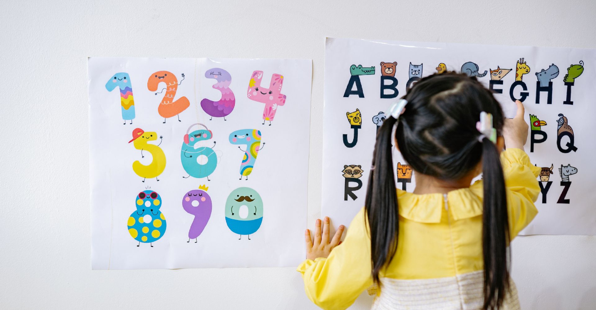 Preschool kid learning the alphabet and numbers.