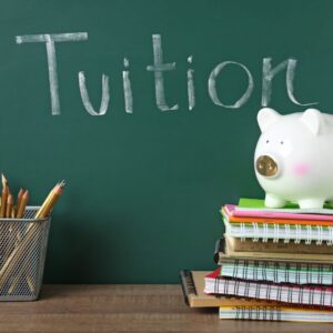 school supplies and chalk board with tuition