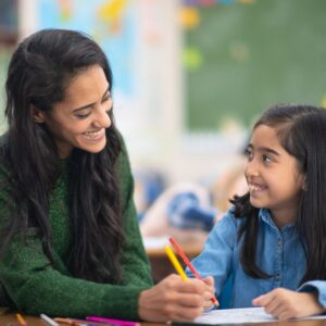 teacher helping child with homework