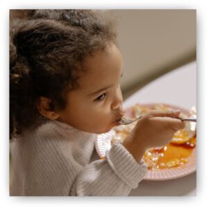 img of a child eating breakfast