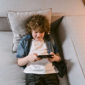boy on phone on couch