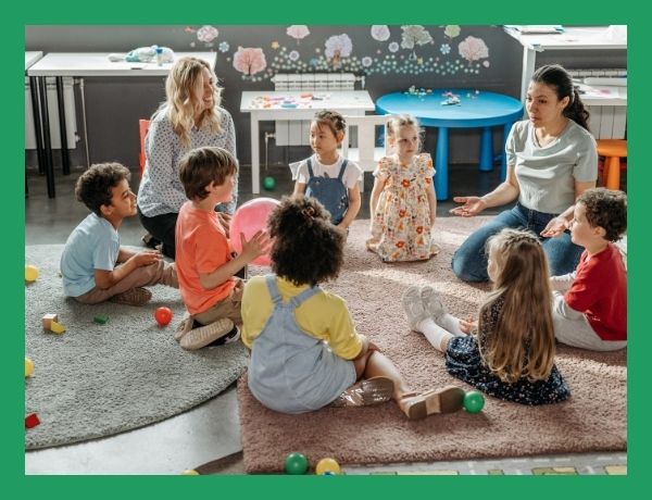 preschoolers sitting in a circle listening to teacher